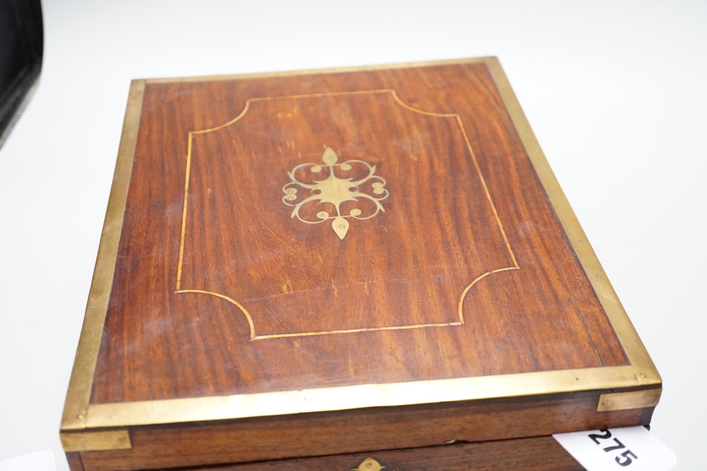 An Anglo-Indian wooden brass bound sewing box, with fitted interior and removable sections, hinged bevelled mirror, internal glass lid, etc. lock marked Birmingham, 26cm x 31cm x 14cm